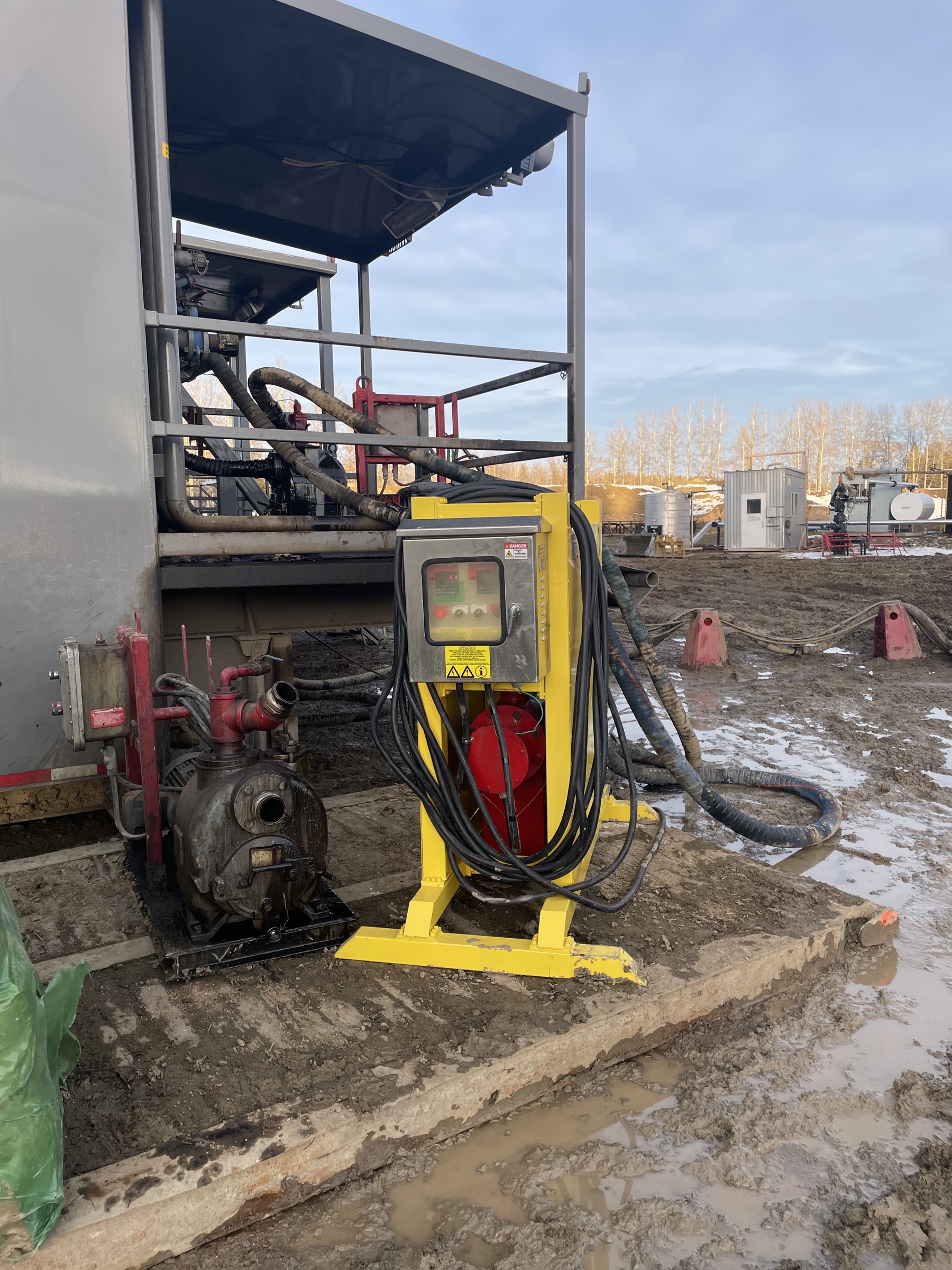 A Burto heater set up beside the rig's transfer pump and storage tanks